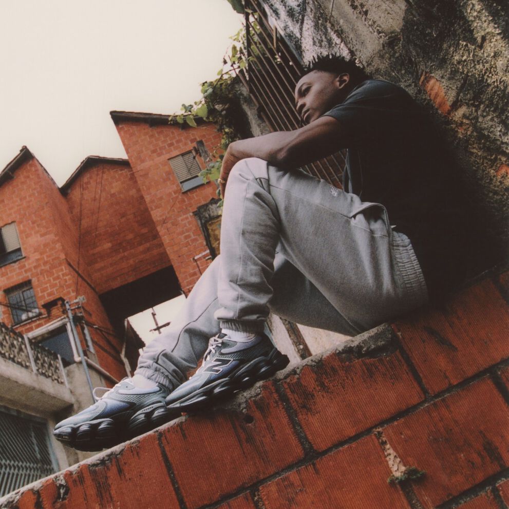 A blue and silver shoe sitting on similar colored background. 